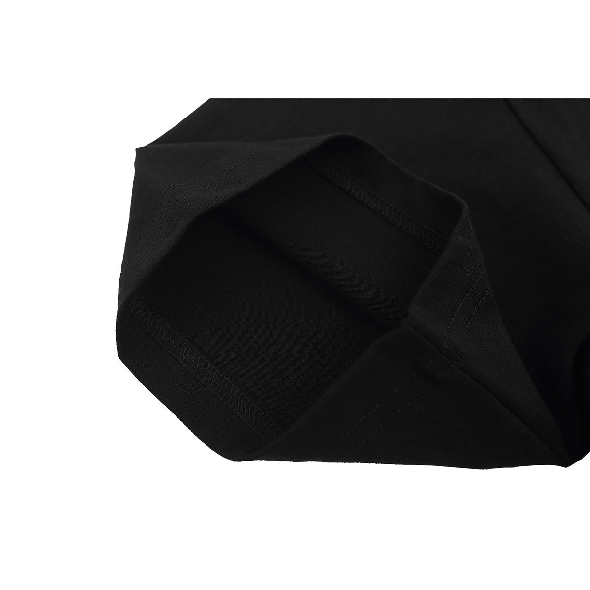 Close-up of the black T-shirt's folded fabric and stitched hem seam.