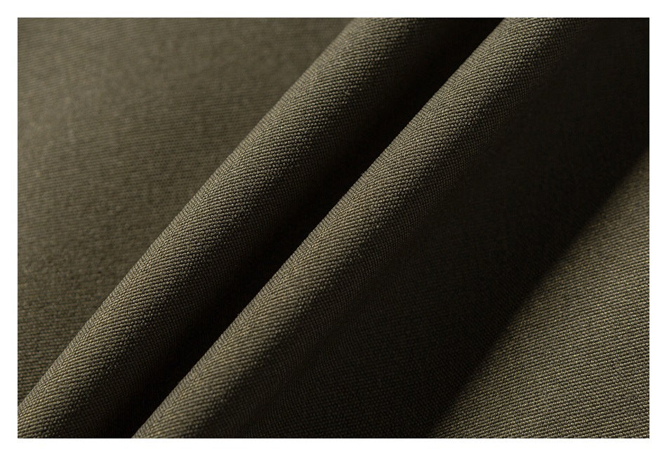 Macro view of textured olive fabric folded to show its surface.