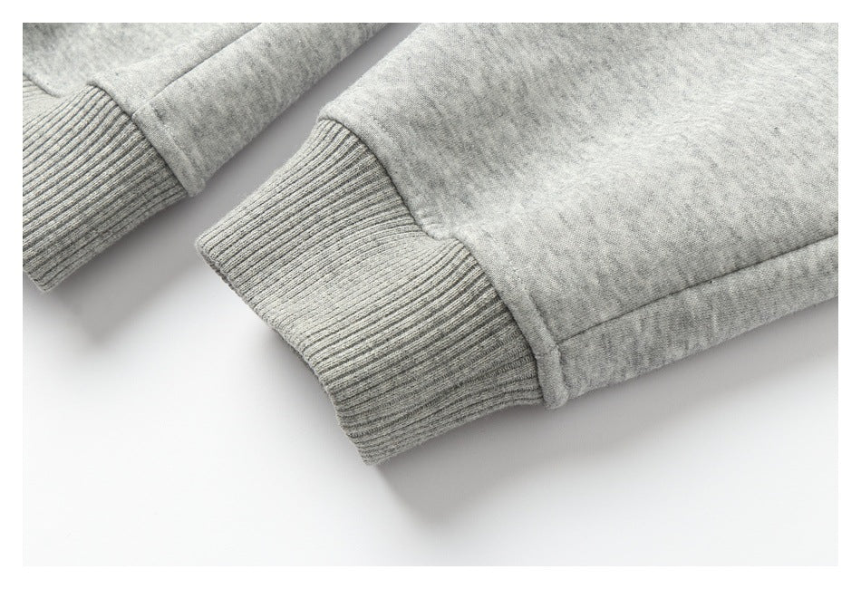 Close-up of ribbed cuffs on the sleeves of a light heather-gray garment.