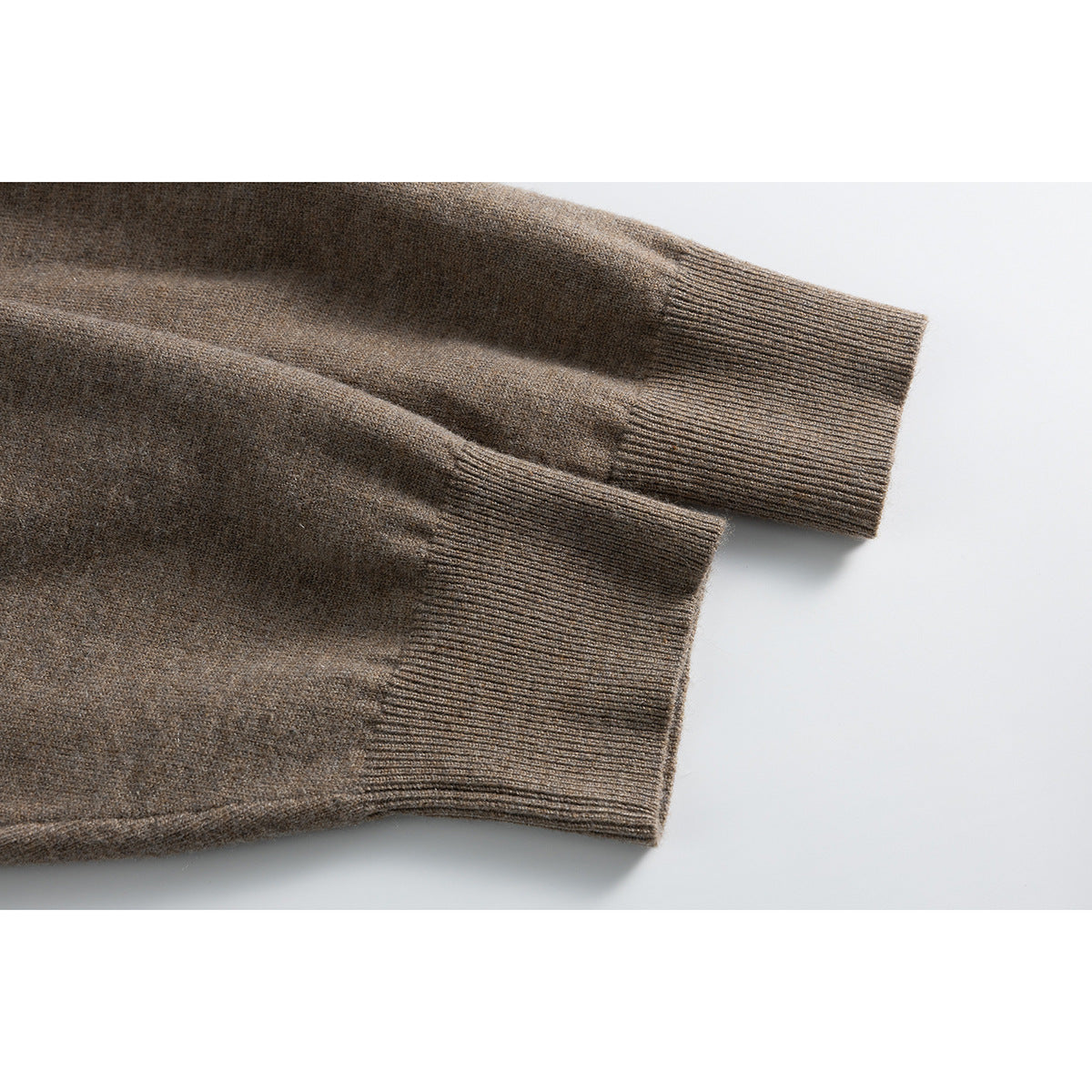 Close-up of the taupe-brown cardigan's long sleeves and ribbed cuffs.