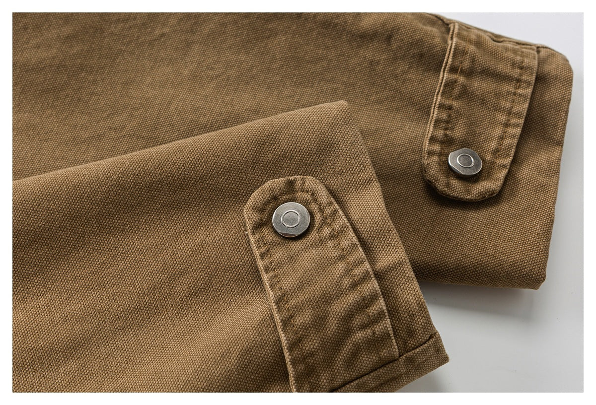 Close-up of two brown textured jacket cuffs with adjustable snap tabs.