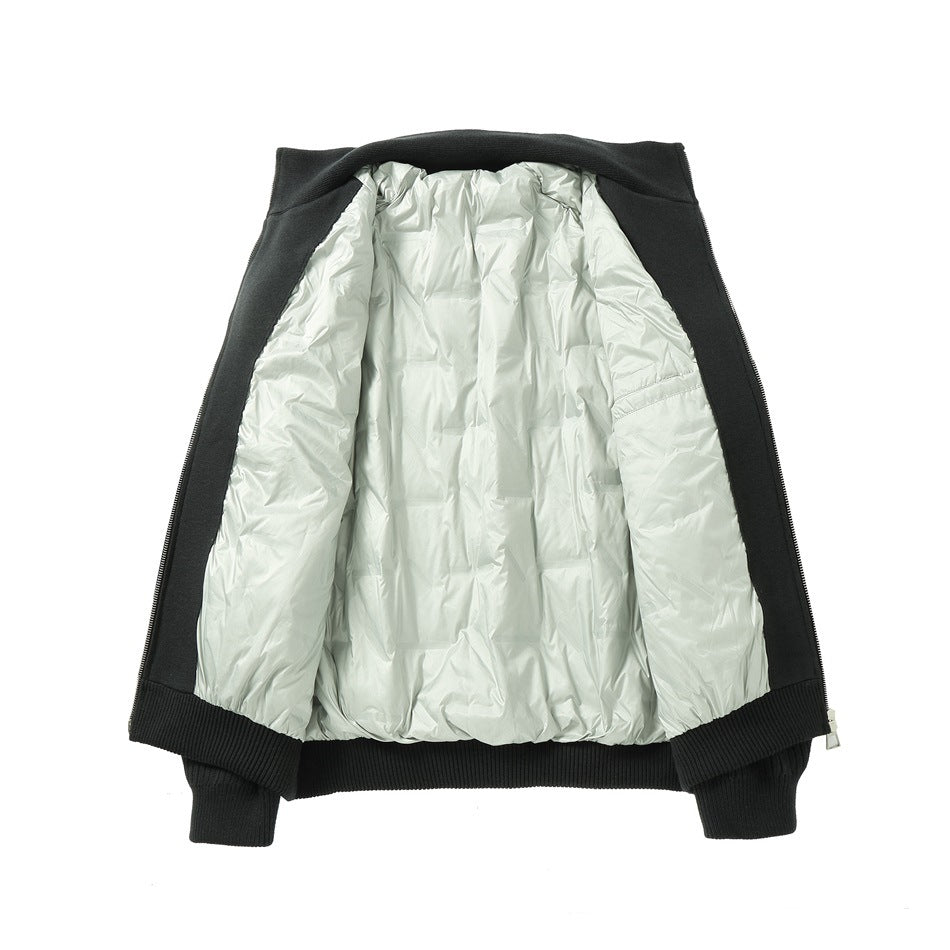 Black jacket laid open flat showing the quilted light gray-green inner layer and ribbed knit edges