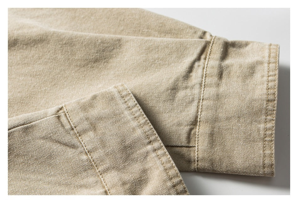 Close-up of the stitched cuff on a beige twill sleeve.
