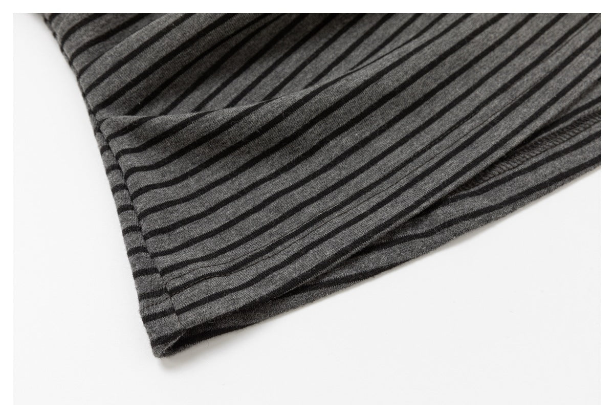 Close-up of the charcoal top's striped lower hem and visible seam stitching.