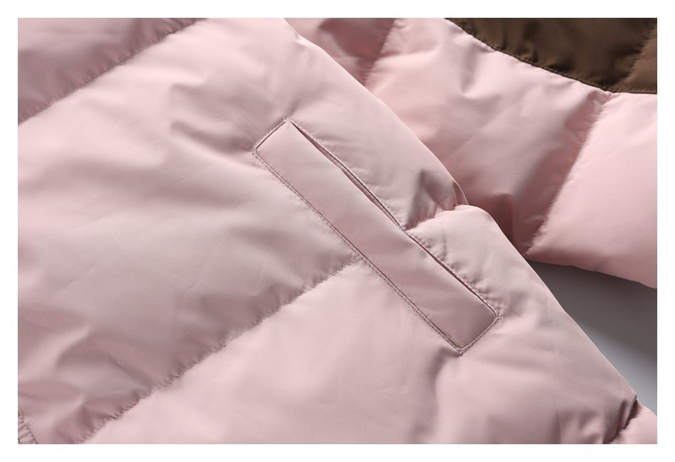 Close-up of a pale pink jacket pocket opening and quilted fabric panels.