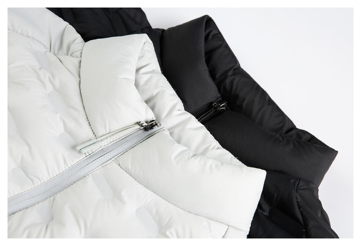 Close-up of white and black quilted jackets, showing the front zippers and padded panels.