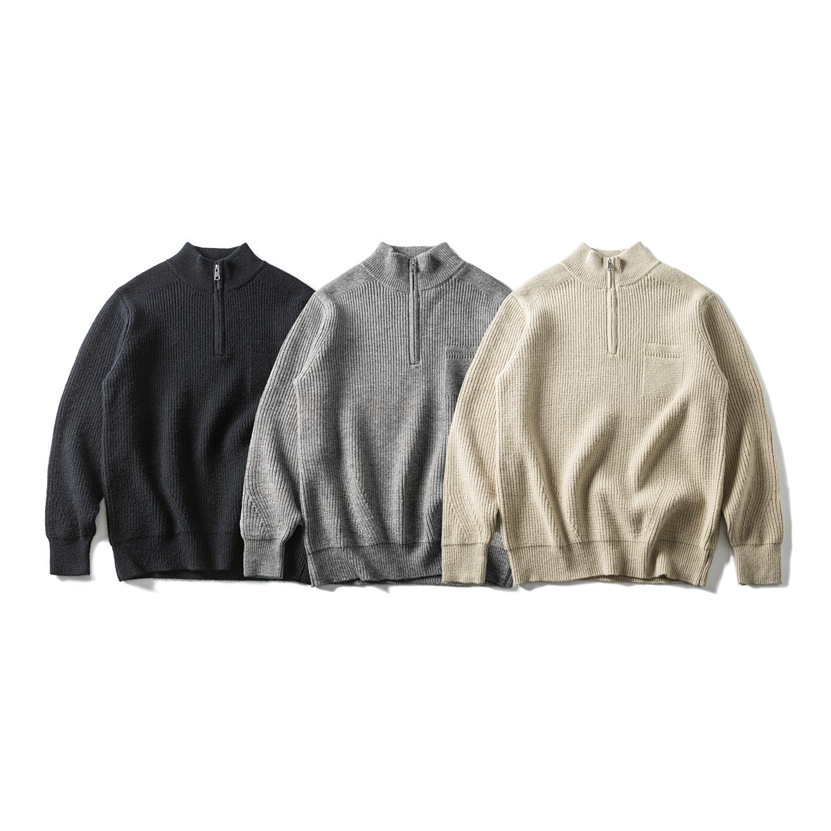 Three front-facing rib-knit quarter-zip sweaters in black, gray, and beige, each with a chest pocket.