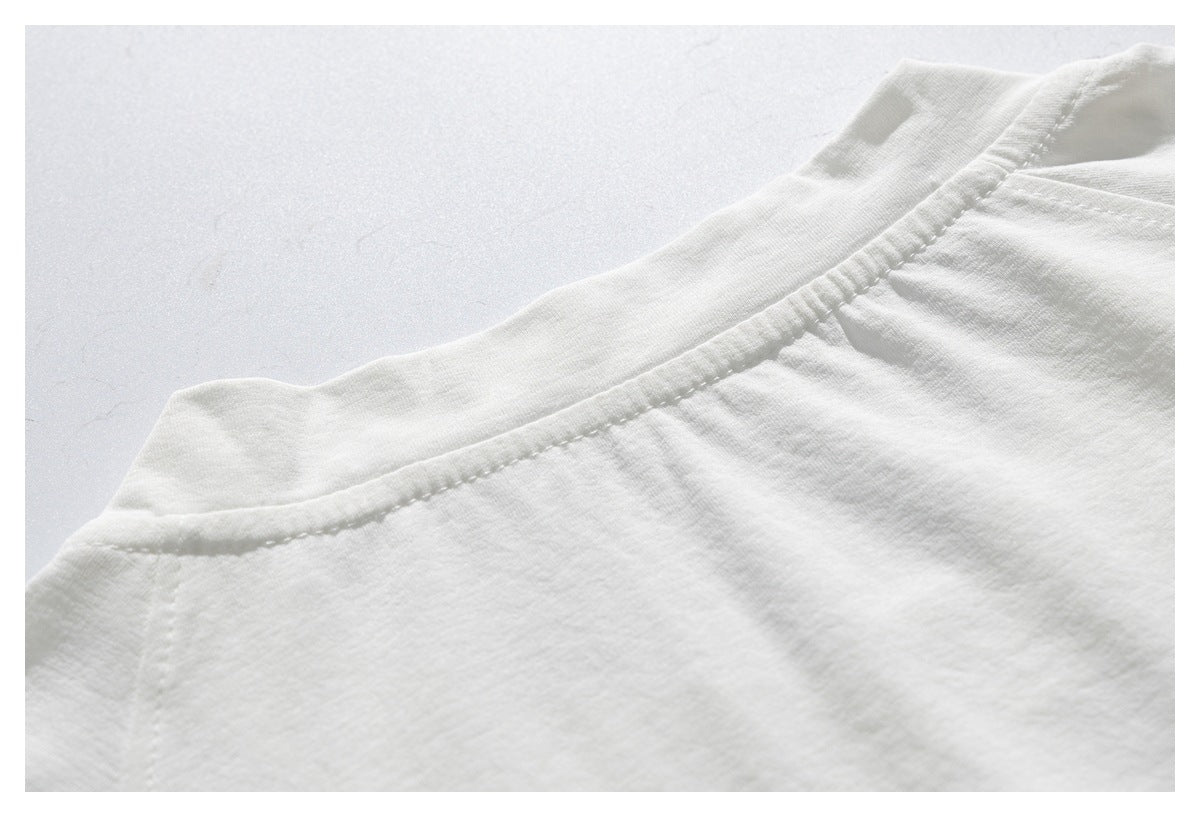 Close-up of the back neckline and stitching on a white shirt.
