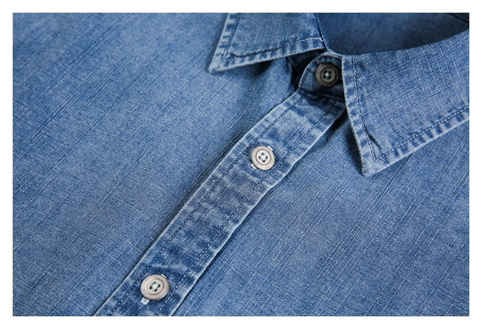 Close-up of a blue button-up shirt's collar, front placket, and buttons.