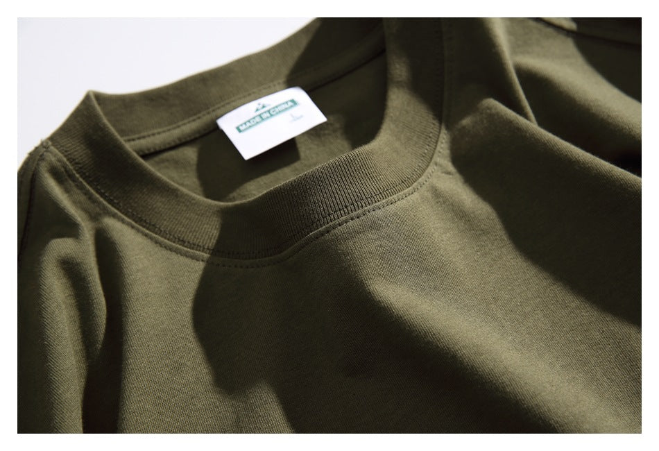Close-up of the olive green T-shirt's ribbed crew neckline and interior neck label.