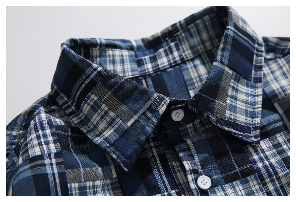Close-up of the shirt's pointed plaid collar and white buttons against its navy, blue, gray, and white check pattern.