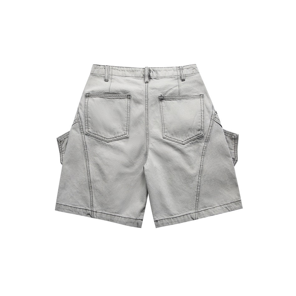 Light gray washed denim-style shorts, back view, with two patch pockets and paneled seams