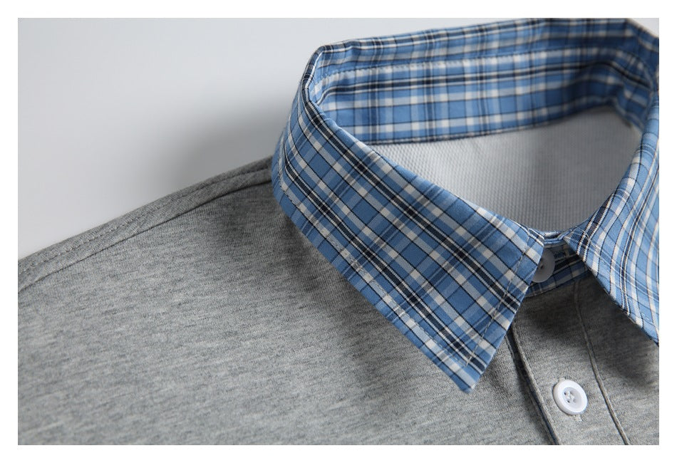 Close-up of the blue plaid collar and gray shoulder of a shirt.