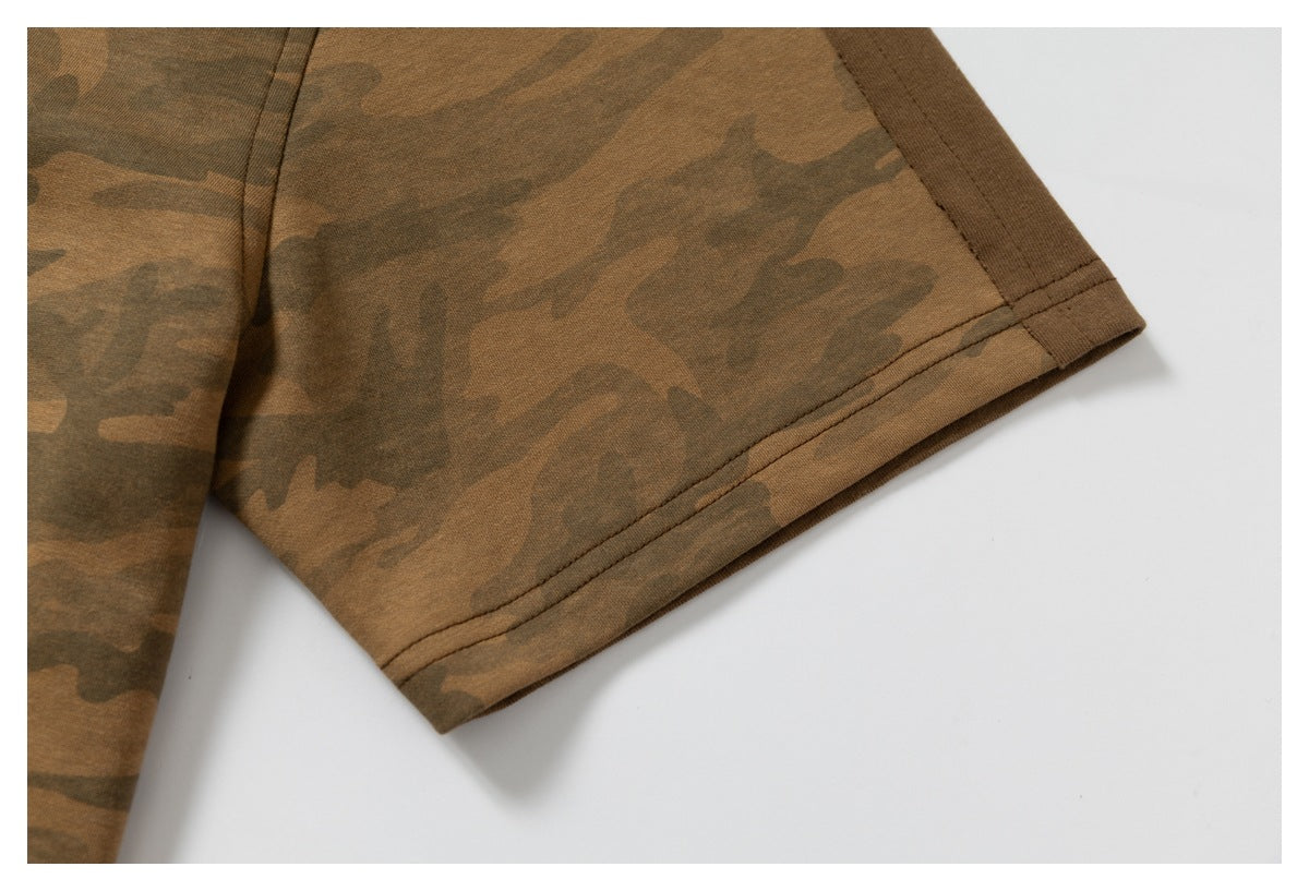 Close-up of the stitched sleeve hem on a brown camouflage garment.