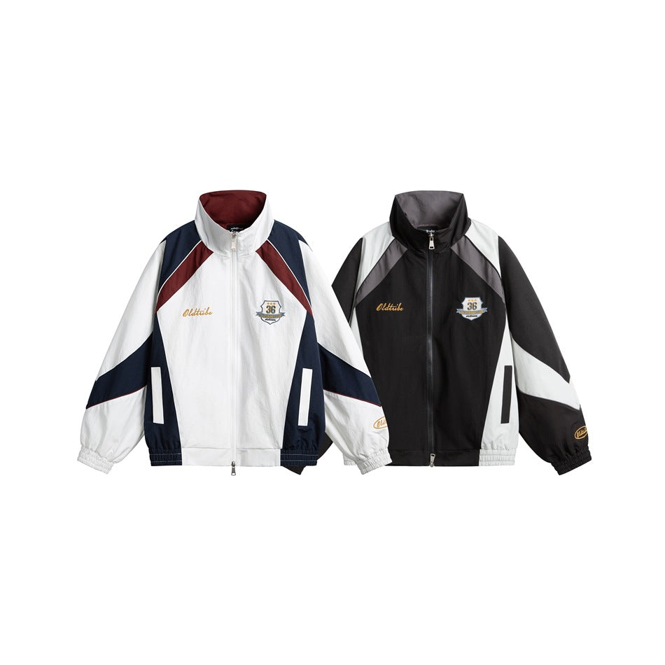 Two zip-front track jackets shown from the front: one white, burgundy and navy; the other black, gray and white.