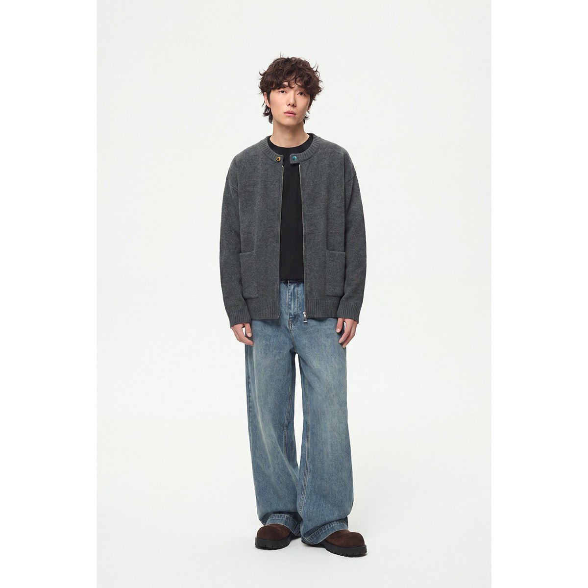Model wearing a charcoal gray knit cardigan with a front zipper, contrast buttons, ribbed trim and two patch pockets.
