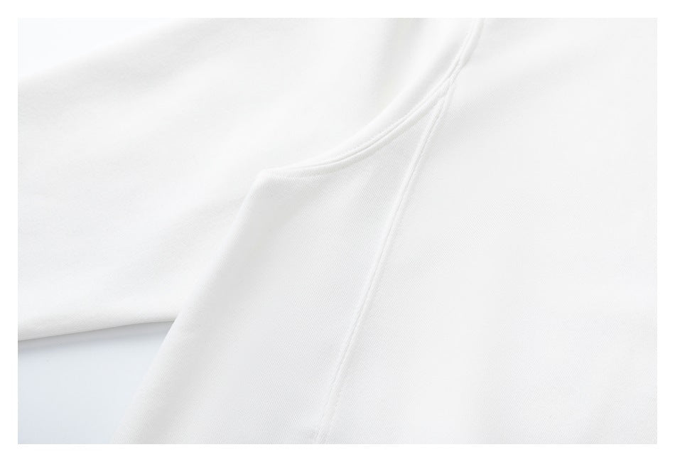 Close-up showing a stitched seam where white garment panels meet.