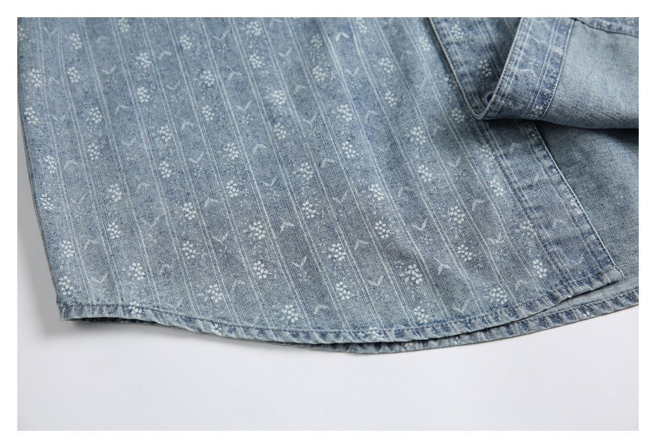 Close-up of the blue patterned shirt's curved lower hem and button placket.