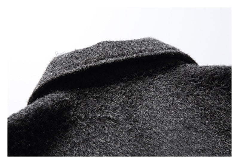 Close-up of the folded collar on a charcoal gray fuzzy coat.