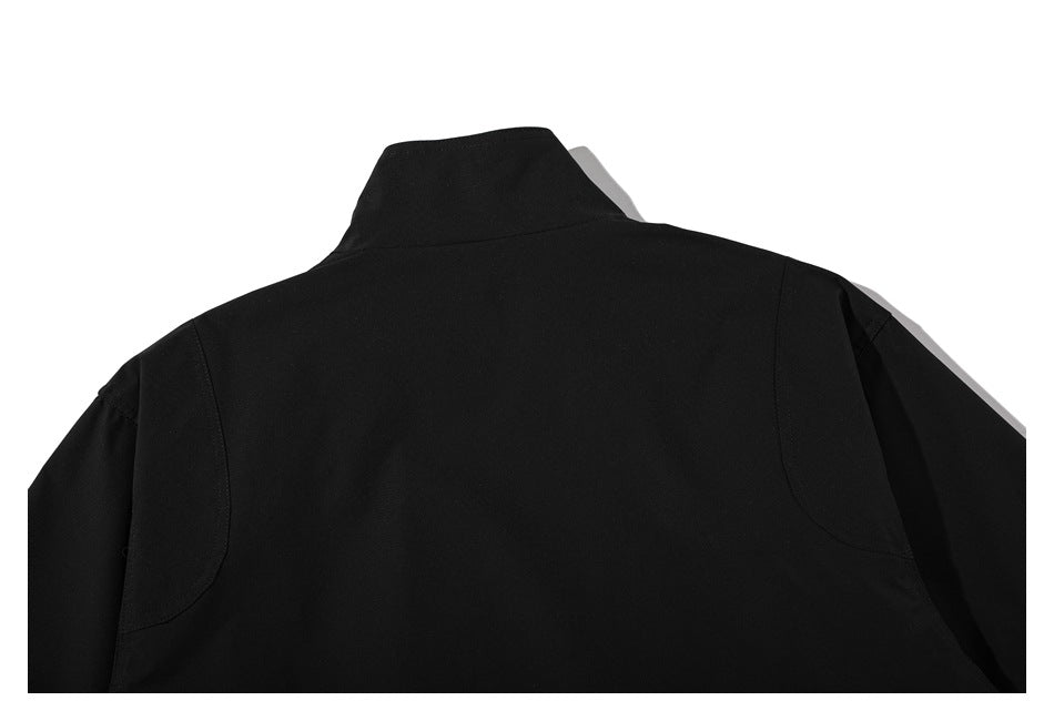 Back view of a black jacket with a raised collar and curved shoulder seams.