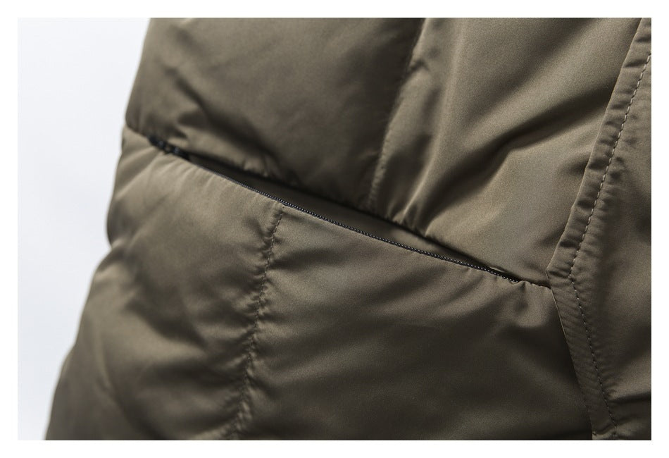 Close-up of a slim horizontal zipper pocket on the olive-khaki vest.