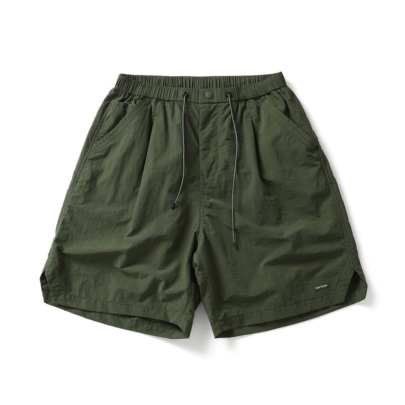 Army green knee-length shorts with drawcord waist, pleats and side pockets, flat lay front view