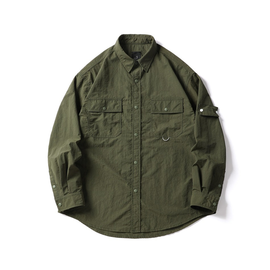 Army green long-sleeve utility shirt with two flap chest pockets, snap placket and sleeve strap, flat lay front view