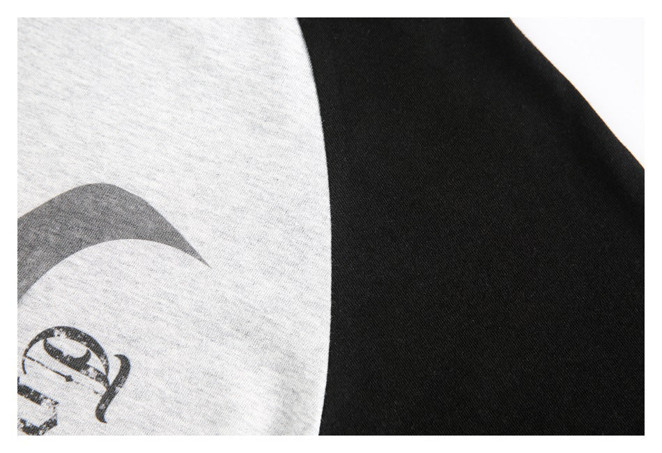 Close-up of a heather gray shirt graphic beside a solid black panel.