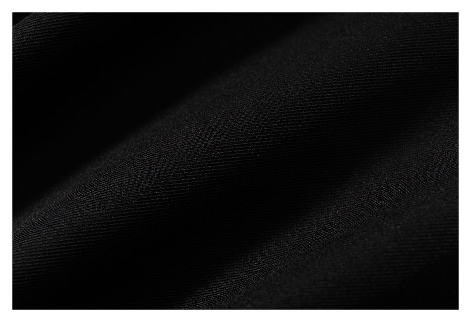 Macro view of the fine ribbed texture of black fabric.