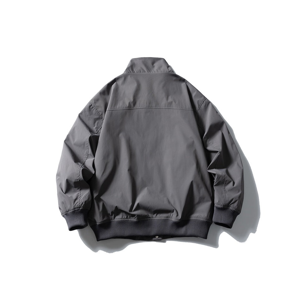 Back view of a gray stand-collar jacket with long sleeves and dark ribbed cuffs and hem.