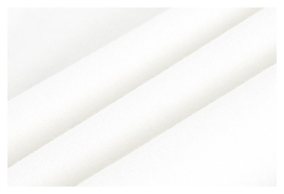 Close-up of smooth white fabric folded into diagonal ridges.