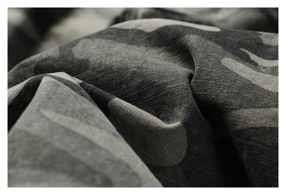 Macro view of the textured gray and black camouflage trouser fabric.