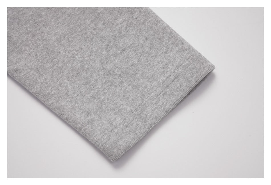 Close-up of the stitched hem on a light gray sleeve.