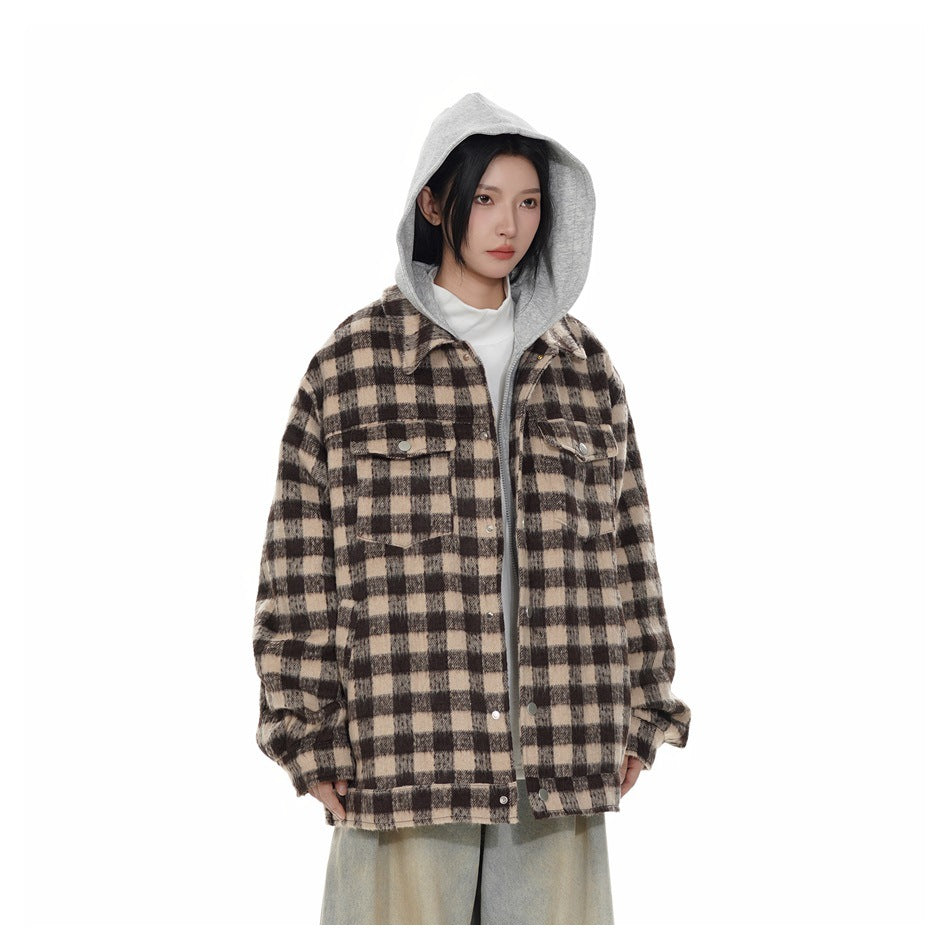 Model wearing a brown and beige plaid button-front jacket with a gray hood, chest pockets, and loose light-wash jeans.