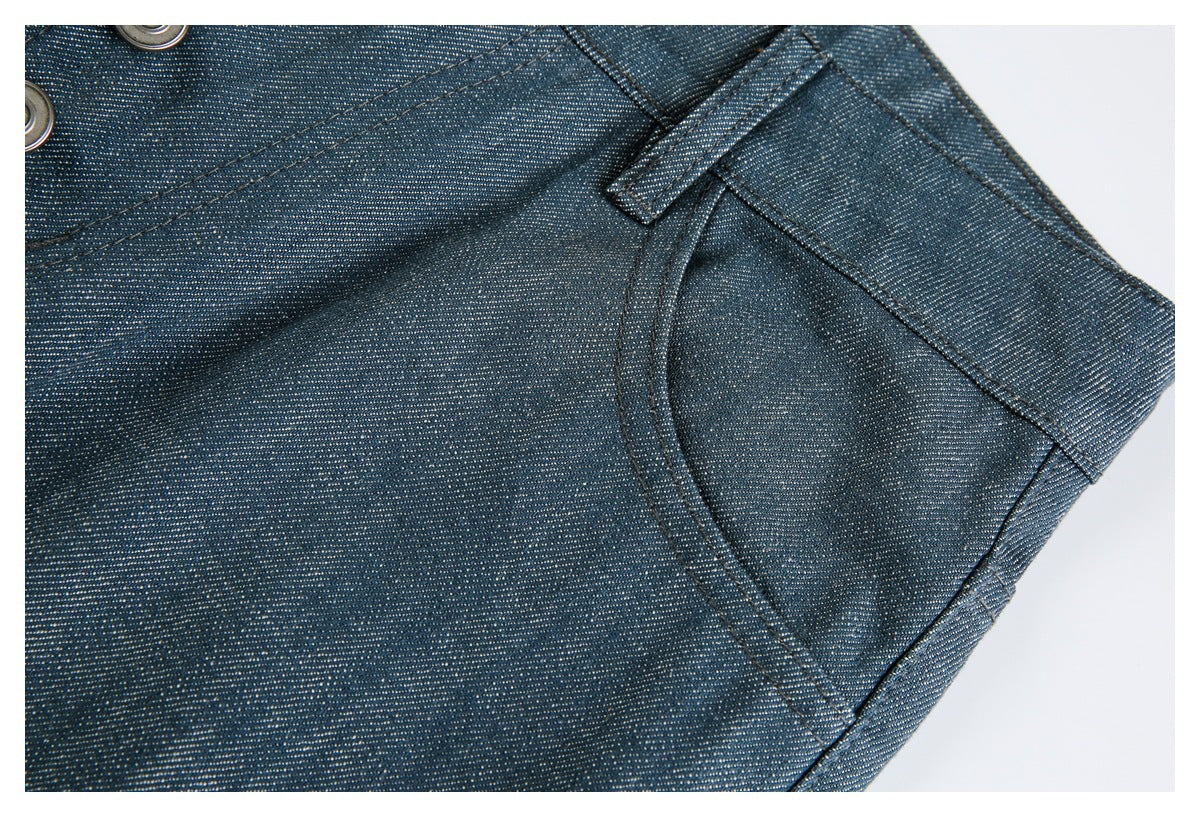 Close-up of dark blue pants showing a belt loop, curved pocket seam, and textured fabric.