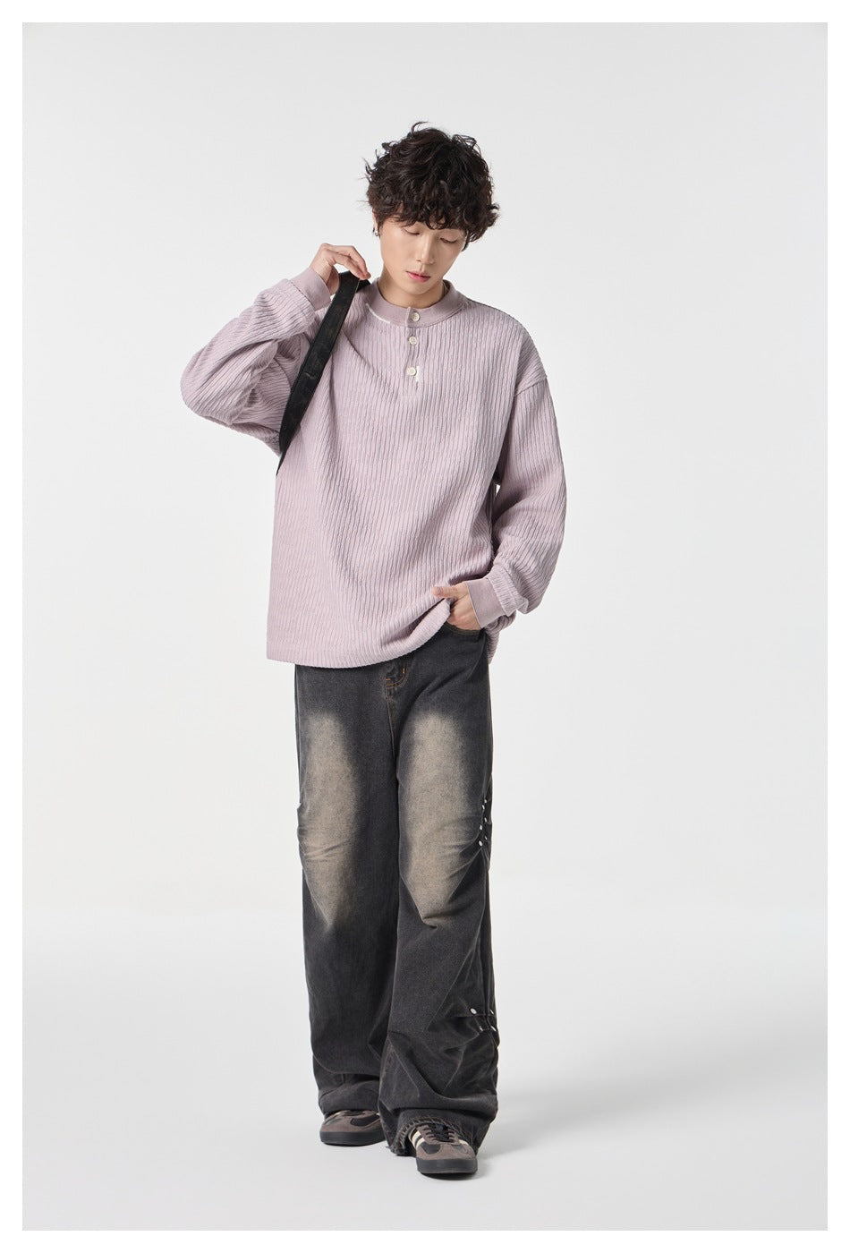 Model wearing a dusty lilac ribbed long-sleeve top with a stand collar and three-button placket.