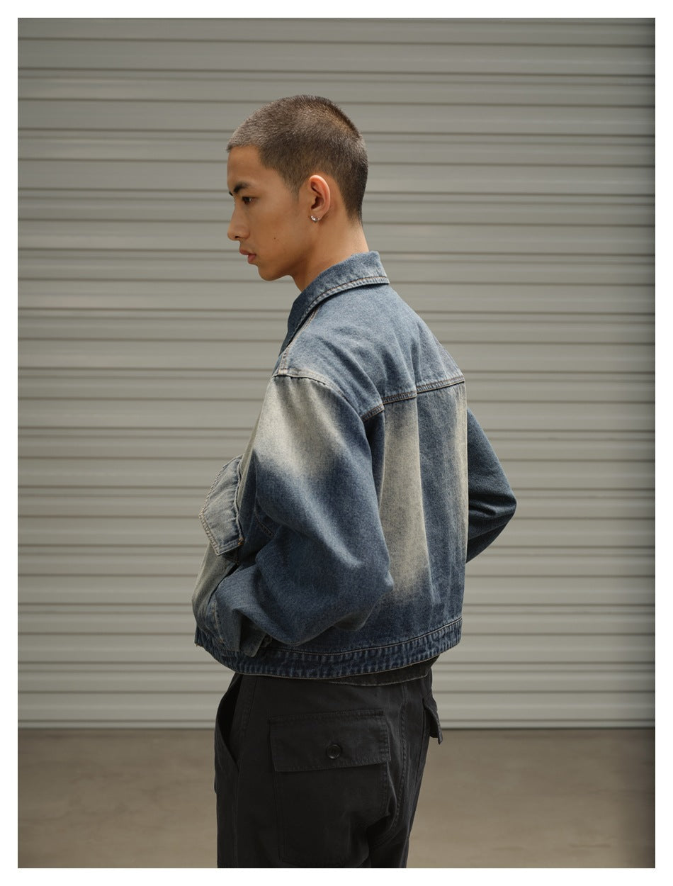 Side and back view of a model wearing a faded blue denim jacket and black cargo trousers.