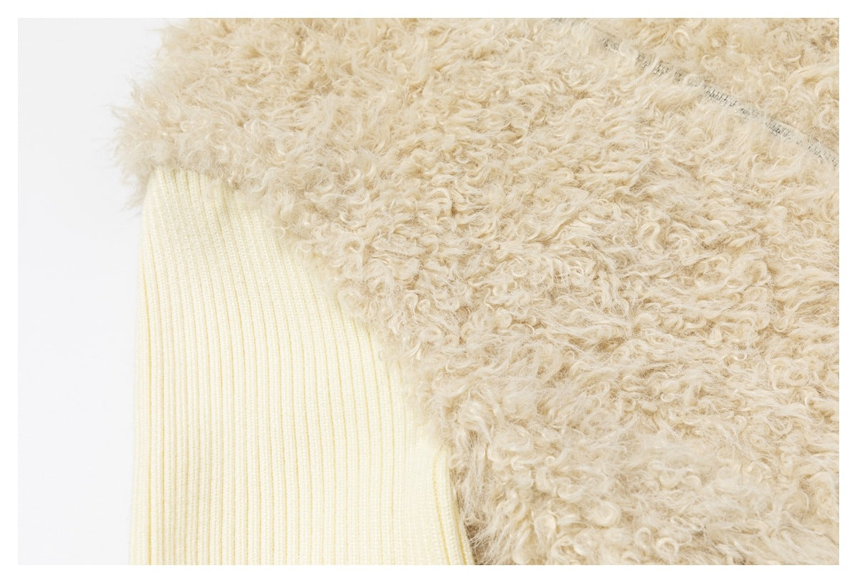 Close-up of the shaggy beige jacket panel beside an ivory ribbed sleeve.