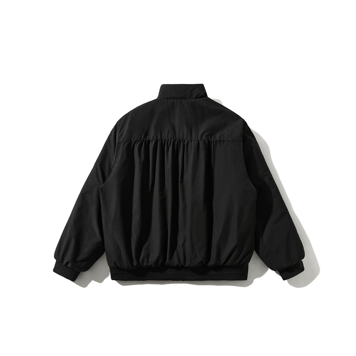 Back view of a black jacket with a high collar, gathered back panel, and ribbed cuffs and hem.