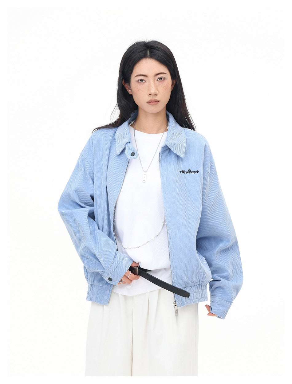 Closer front view of a model wearing an open light blue collared jacket over a white top.