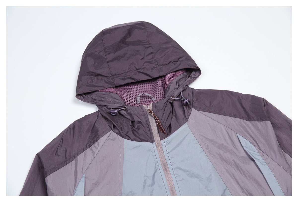 Close-up of the jacket's color-block front, hood lining, drawcords, and front zipper.