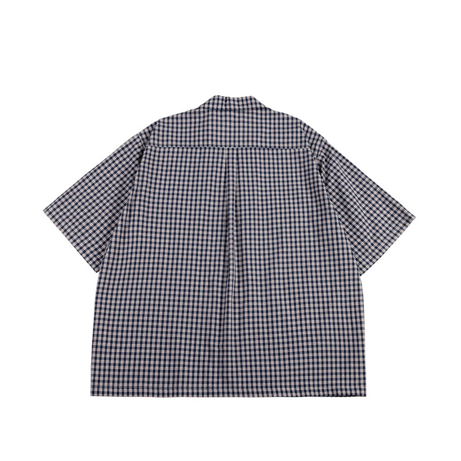 Navy small-check short-sleeve shirt, flat back view with yoke and center pleat