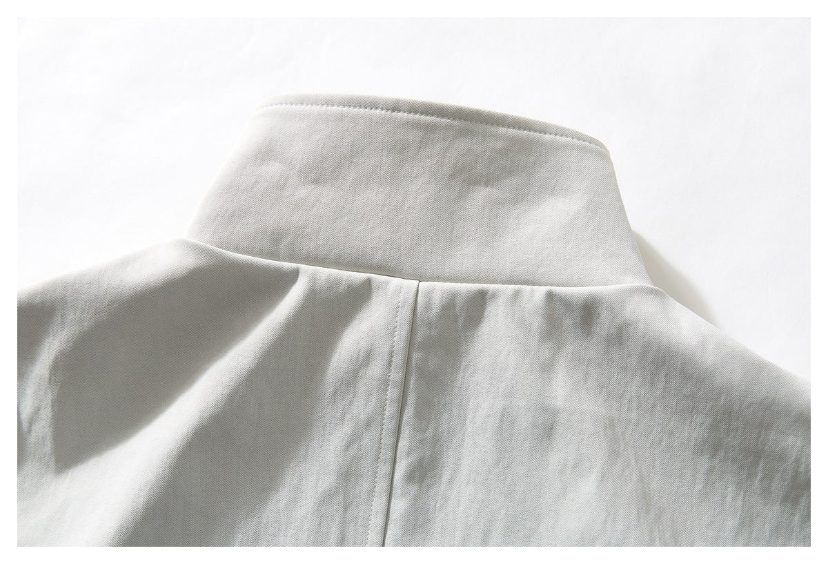 Close-up of a light gray garment collar and center back seam.