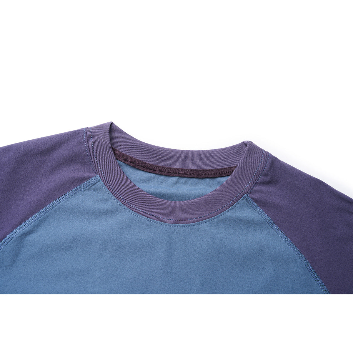 Close-up of a blue raglan shirt neckline with a purple ribbed collar and visible stitching.