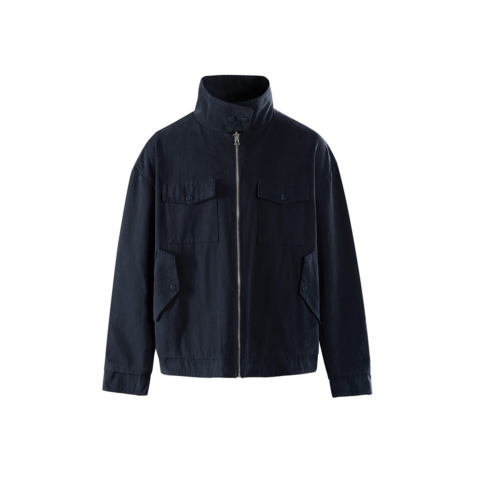 Navy stand-collar zip jacket with chest flap pockets and angled snap pockets, front view on white background