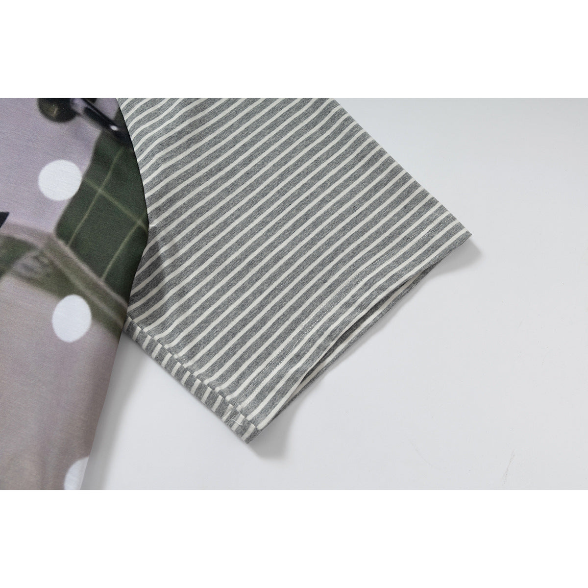 Close-up of a gray-and-white striped short sleeve beside the shirt's lavender printed front.