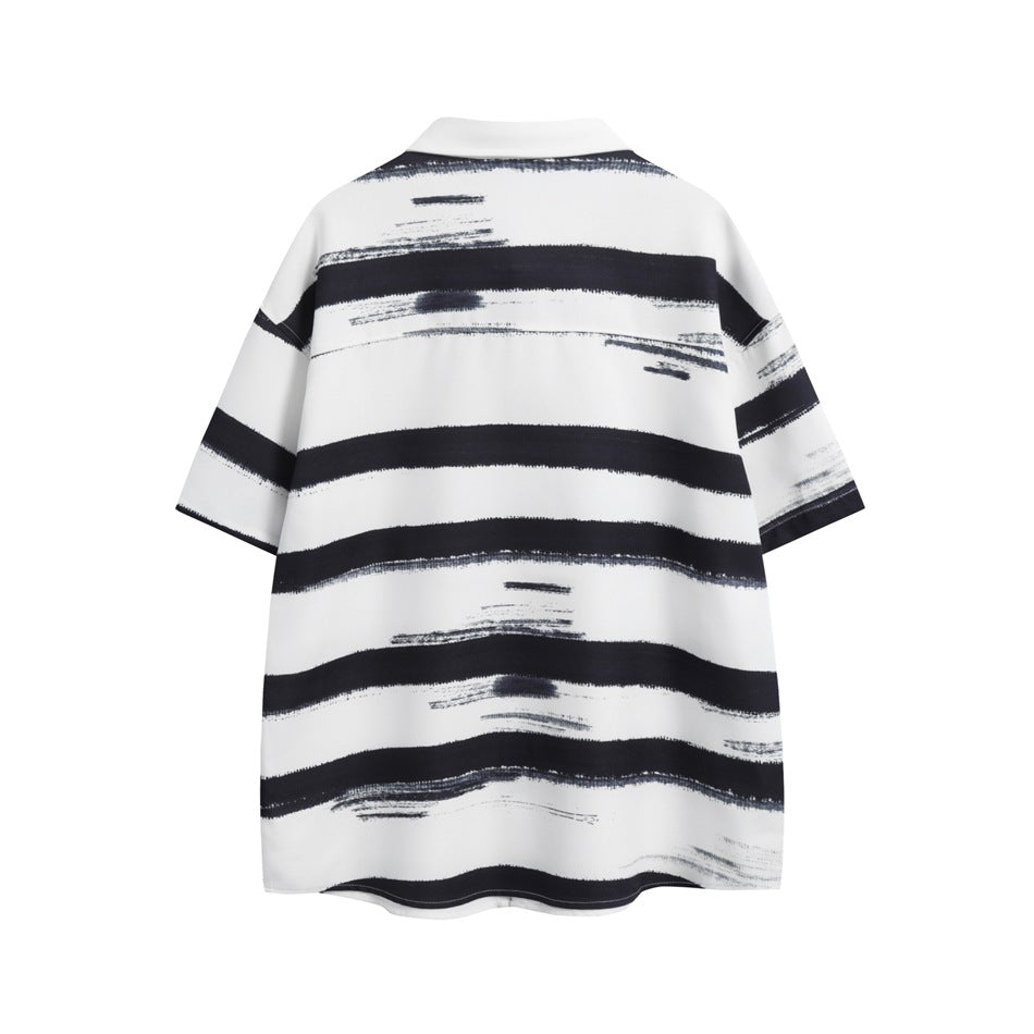 Back view of a white short-sleeve collared shirt with irregular horizontal black brushstroke stripes.