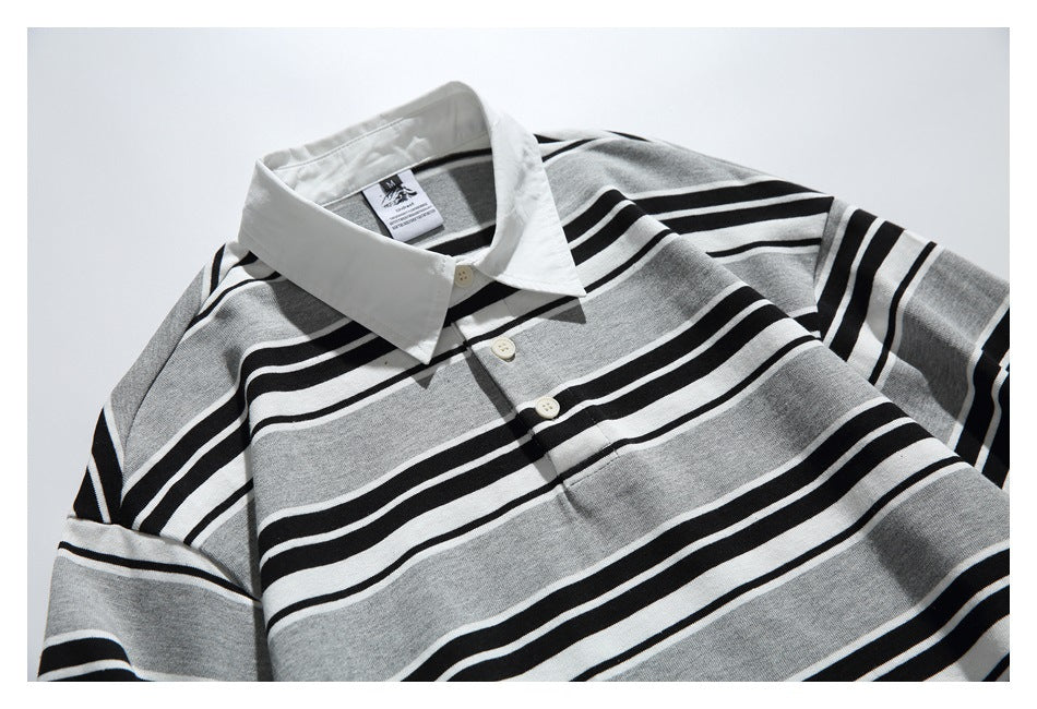 Close view of the striped shirt's white pointed collar and short button placket.