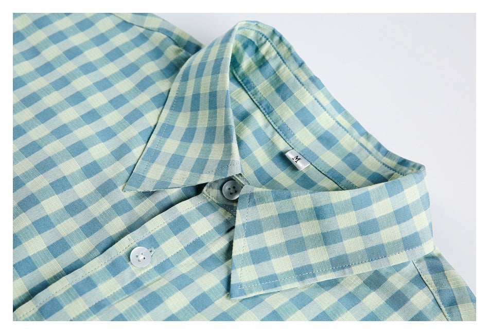 Close-up of the collar, buttons, and gingham pattern on a teal, pale yellow, and white shirt.