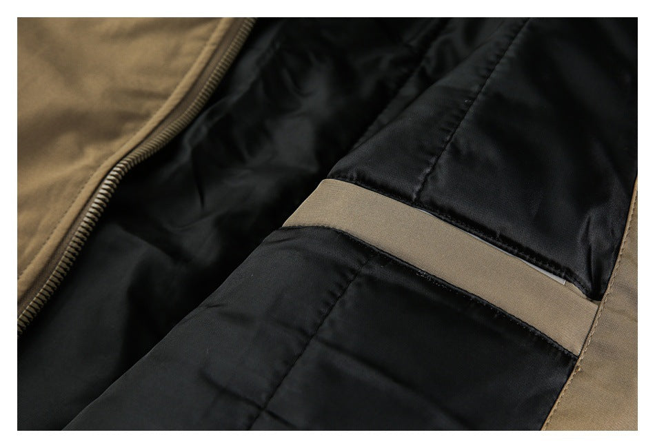 Close-up of black garment lining with a wide taupe band and tan outer fabric.